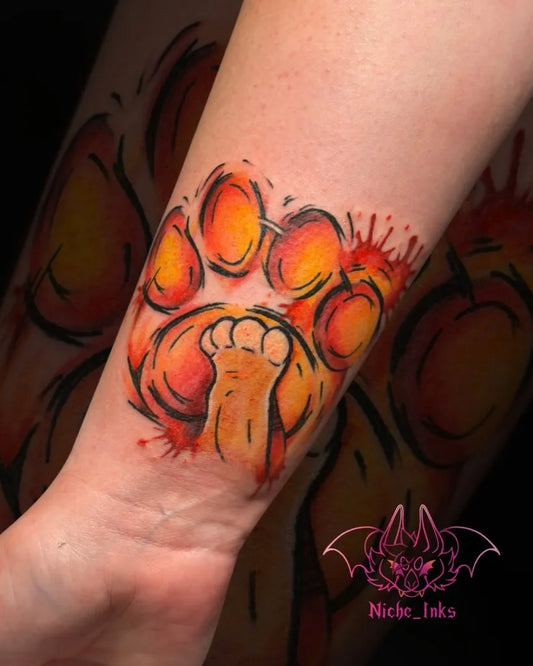 Medium Watercolor Paw Print with Splatter Tattoo on Women Wrist by @memorylane.tattoos