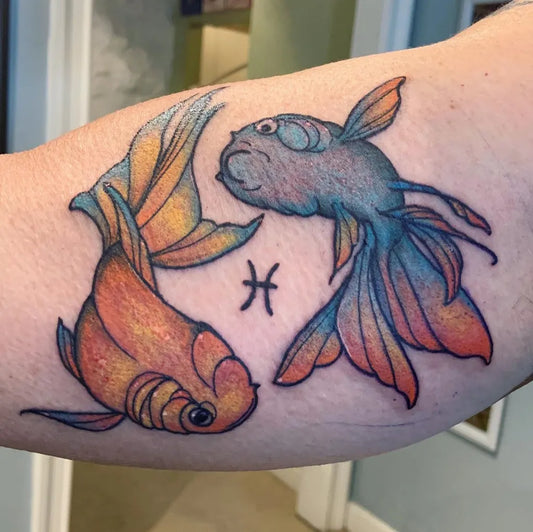 Medium Watercolor Pisces Fish Tattoo on Women Arm by @tattoosbyhaileemarie