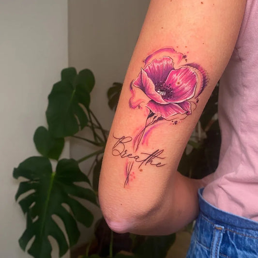 Medium Watercolor Poppy and Breathe Script Tattoo on Women Arm by @deniseferrati.tattoo