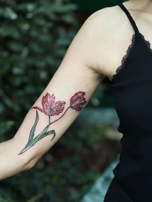 Medium Watercolor Two Tulips Tattoo on Women Upper Arm by @tattoo.bloom