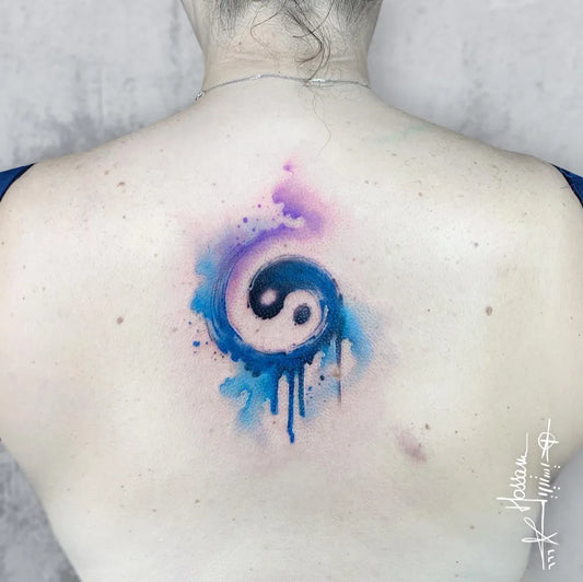 Medium Watercolor Yin Yang Tattoo on Women Back by @hossam.tattoos