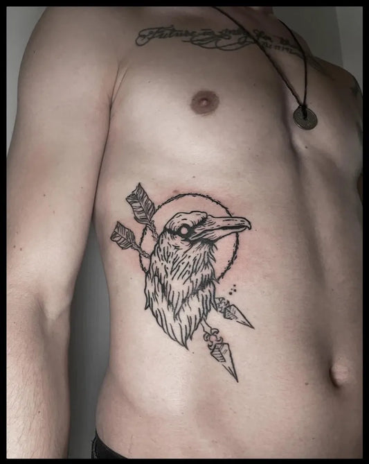 Medium Woodcut Crow with Arrows and Halo Tattoo on Men Ribcage by @thomasdunkelbunttattoo