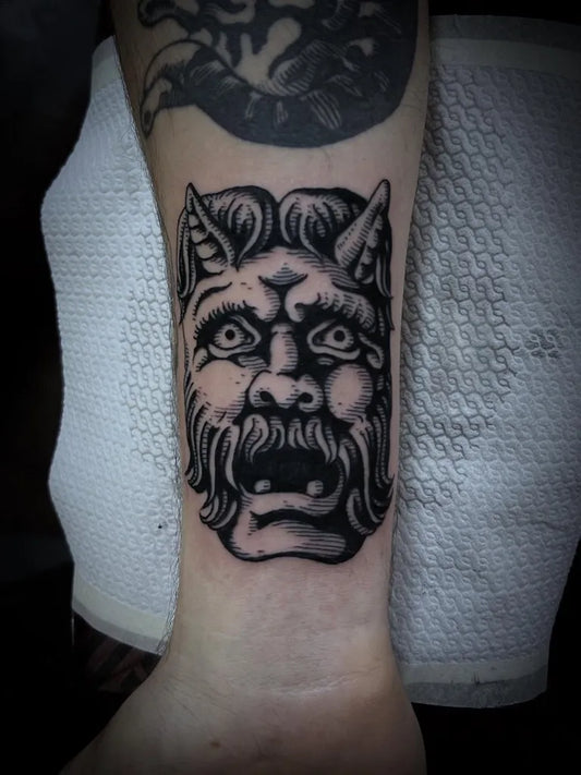 Medium Woodcut Demonic Face Tattoo on Men Wrist by @davide.mancini