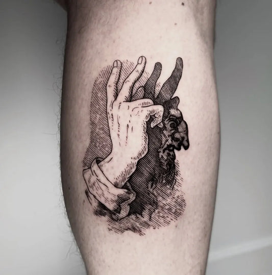 Medium Woodcut Hand Casting Shadow Puppet Tattoo on Men Arm by @krueger.ink