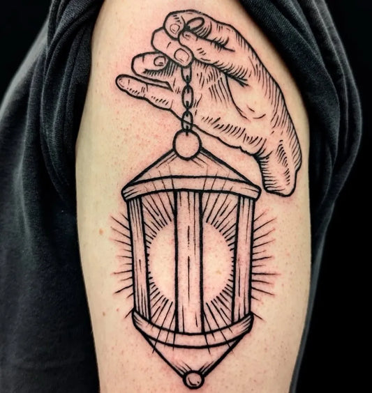 Medium Woodcut Hand Holding Lantern Tattoo on Men Upper Arm by @fattystattoosandpiercings
