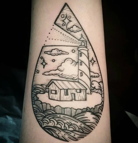 Medium Woodcut Lighthouse Teardrop with House and Waves Tattoo on Women Arm by @splashtattoos
