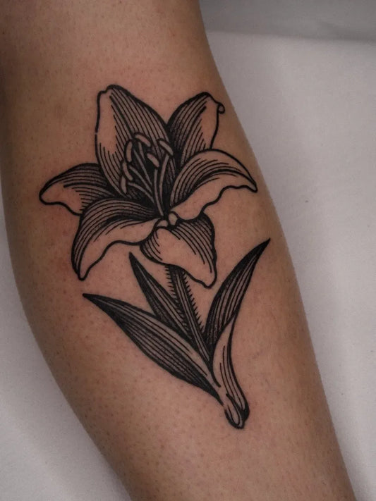 Medium Woodcut Lily Flower Tattoo on Women Arm by @saiz.ttt