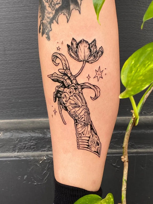 Medium Woodcut Lotus Hand Tattoo on Women Leg by @silly_little_tattooist
