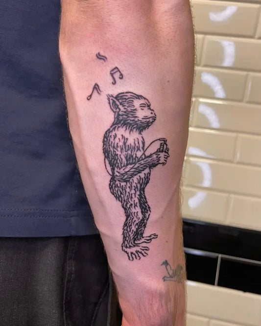 Medium Woodcut Monkey with Drum Tattoo on Men Arm by @5.5volt_tattoo