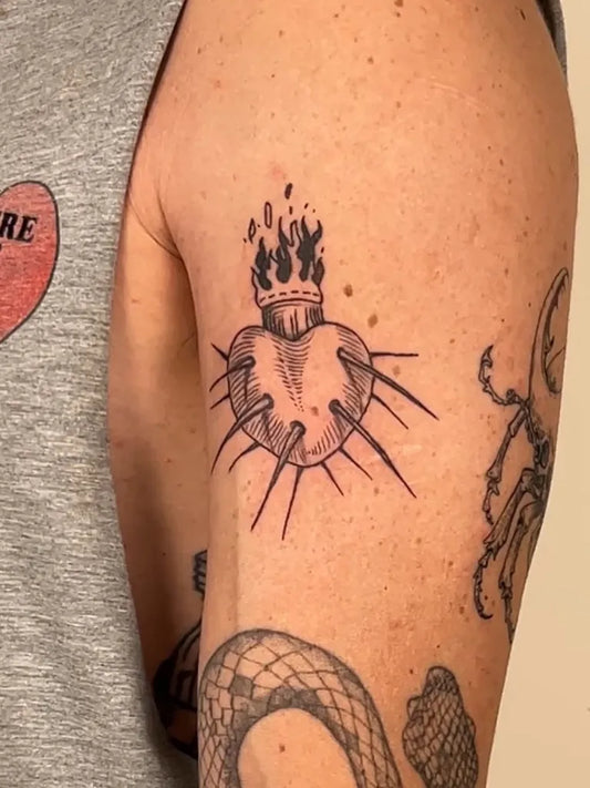 Medium Woodcut Sacred Heart with Flames and Thorns Tattoo on Men Arm by @tezerd_