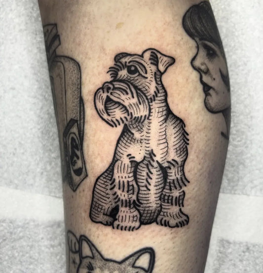 Medium Woodcut Schnauzer Dog Tattoo on Women Leg by @evieholmestattoo