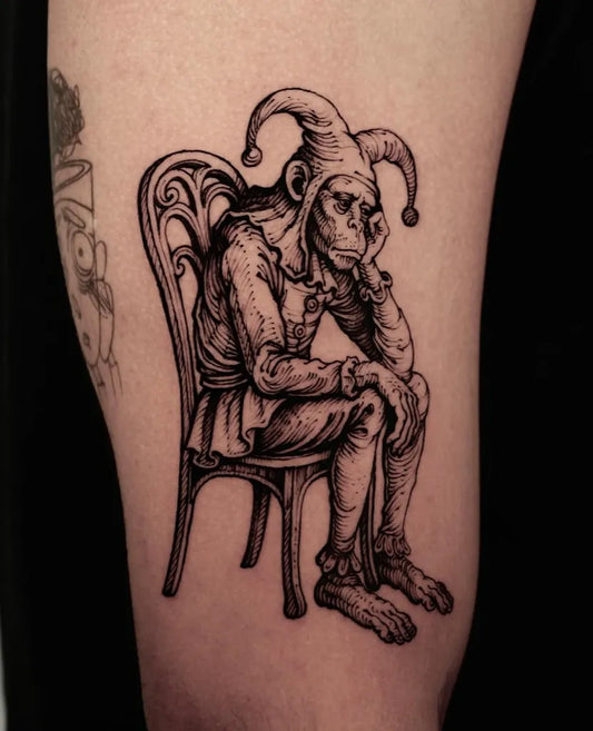 Medium Woodcut Sitting Monkey Jester Tattoo on Men Arm by @vox.maeot