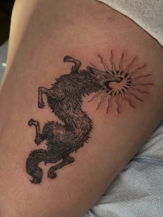 Medium Woodcut Wolf and Sun Tattoo on Women Thigh by @ash.elrey