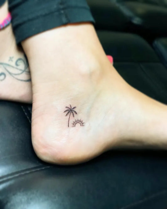 Simple Fine Line Palm Tree and Sun Tattoo on Women Ankle by @thick_as_thieves13