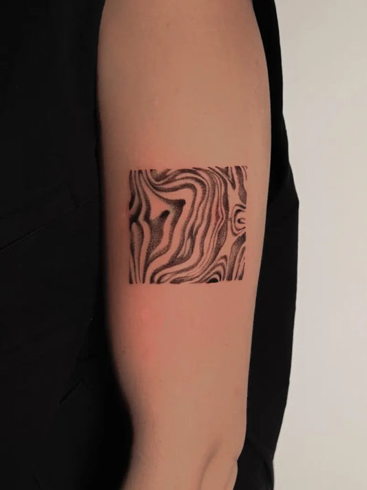 Small Abstract Zebra Pattern Tattoo on Women Arm by @jvd_signature