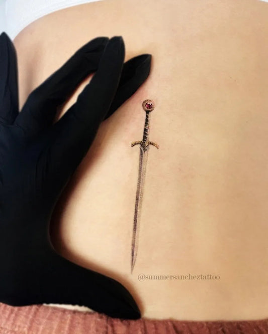 Small Aelins Goldryn Sword on Women Hip Tattoo by @summersancheztattoo