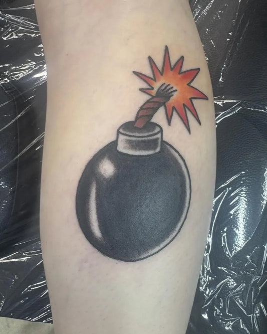 Small American Traditional Bomb on Women Leg Tattoo by @moth_boy_tattoo