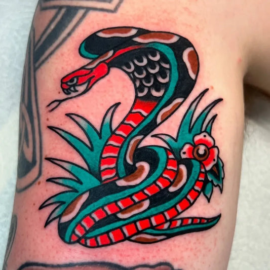 Small American Traditional Cobra Snake with Leaves and Flower on Men Arm Tattoo by @skylar_grove