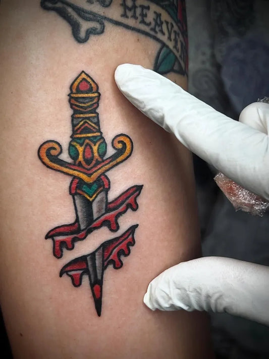 Small American Traditional Dagger with Drips Tattoo on Men Arm by @nutdub