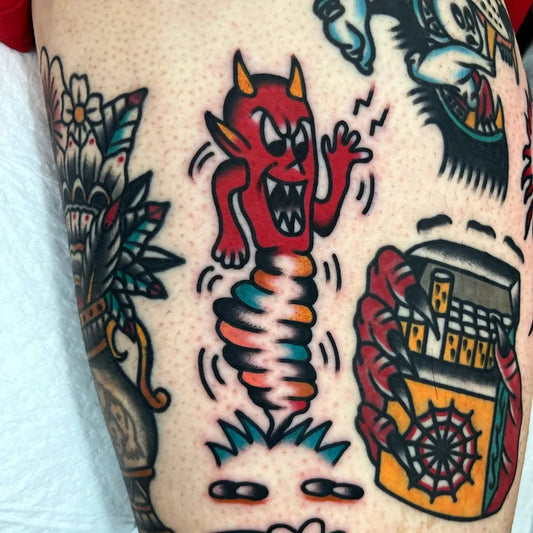 Small American Traditional Devil Cigarette Pack Flowers on Women Arm Tattoo by @joozy_tats
