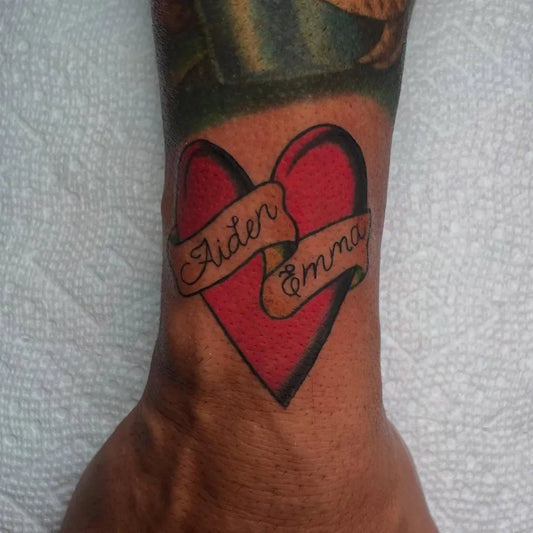 Small American Traditional Heart with Banner on Men Wrist Tattoo by @kenxie.art