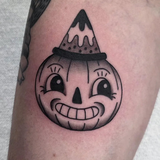 Small American Traditional Jack o lantern Halloween Tattoo on Women Arm by @tattoosbyanisa
