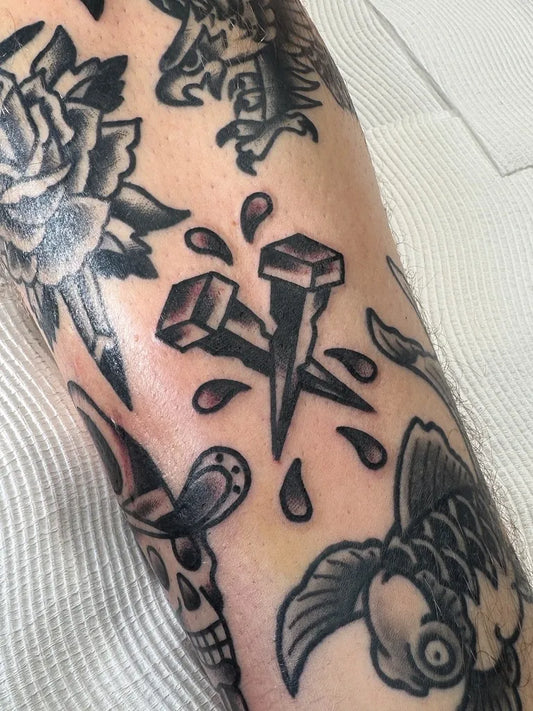 Small American Traditional Nails and Blood Splatter on Men Arm Tattoo by @lukeetho