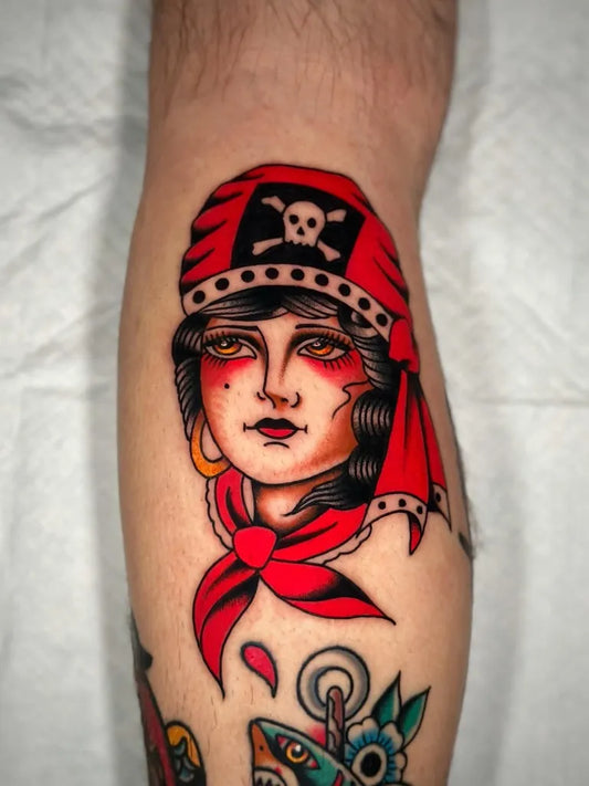 Small American Traditional Pirate Woman with Skull and Crossbones on Men Leg Tattoo by @alexfinnertytattoos