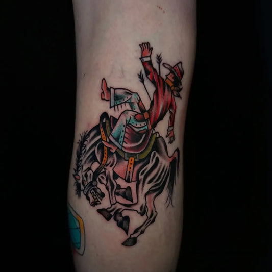 Small American Traditional Rodeo Cowboy on Zebra on Men Arm Tattoo by @sideshowtattooandpiercing
