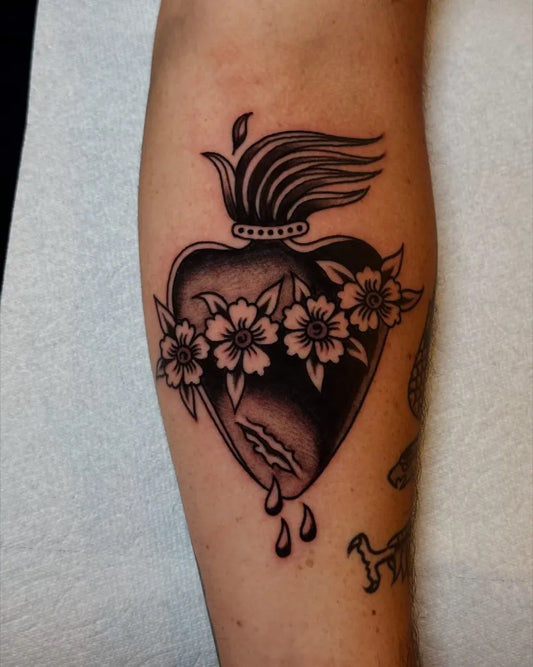 Small American Traditional Sacred Heart with Flowers on Women Arm Tattoo by @dante__royal