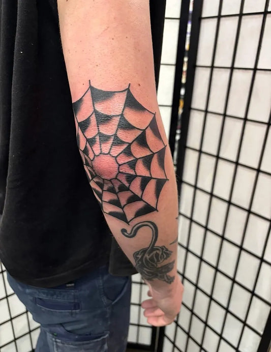 Small American Traditional Spider Web with Spider on Men Forearm Tattoo by @rudietattoo
