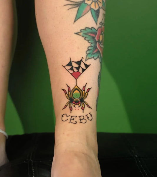 Small American Traditional Spider with Web and Drink on Women Leg Tattoo by @loscarlostattoos