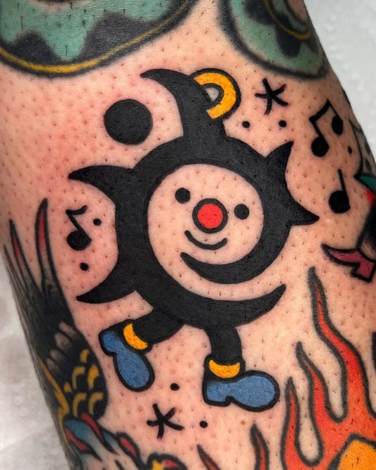 Small American Traditional character with musical notes on Men Arm Tattoo by @its_raw_banana_