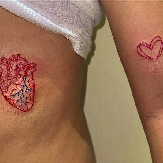 Small Anatomical Heart on Women Rib and Arm Tattoo by @ayoojannink
