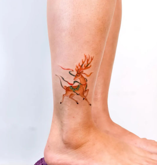 Small Asian Traditional Deer Tattoo on Women Leg by @lllauren.zh.tattoo
