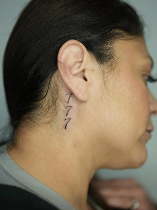 Small Black and Grey 777 Tattoo on Women Neck by @artbynat.tyy