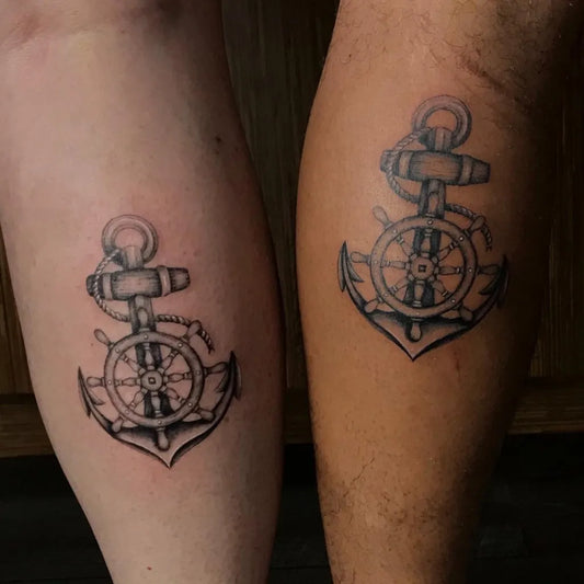 Small Black and Grey Anchor and Wheel Nautical Tattoo on Women Leg by @melbootstattoo