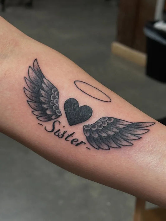 Small Black and Grey Angel Wings Heart and Sister Tattoo on Women Arm by @indigotattz