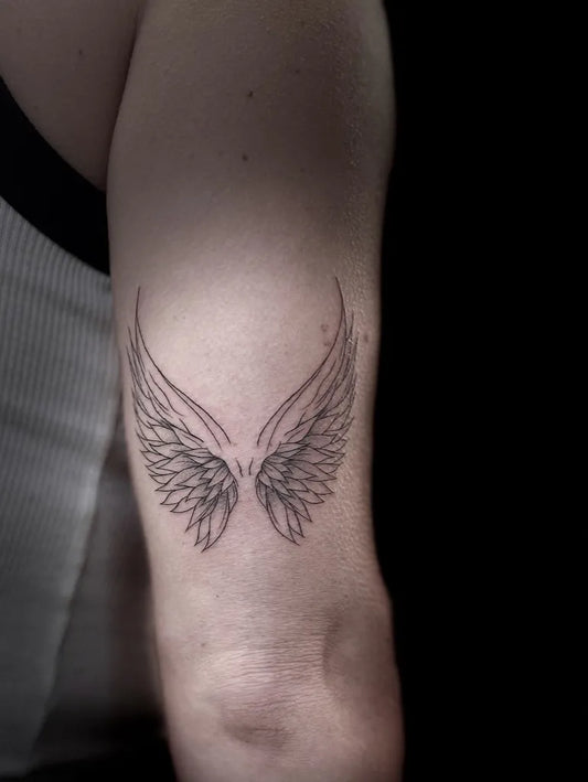 Small Black and Grey Angel Wings Tattoo on Men Arm by @sh8peink_studio