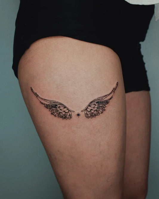 Small Black and Grey Angel Wings Tattoo on Women Thigh by @somewood.in.parra