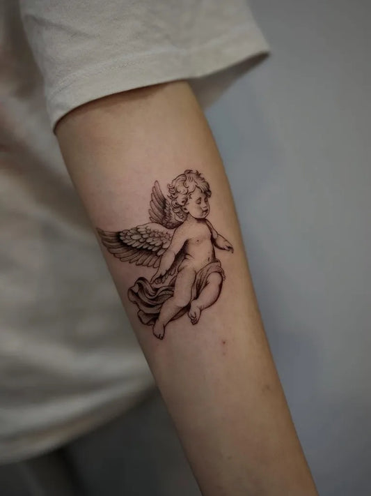 Small Black and Grey Angel with Wings on Women Arm Tattoo by @roza.tattoo