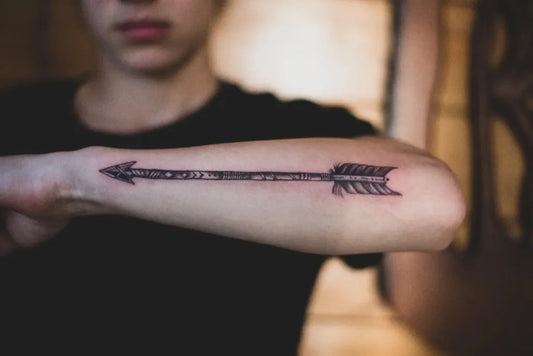 Small Black and Grey Arrow Tattoo on Men Forearm by @amina.s.tattoo