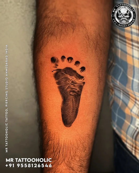 Small Black and Grey Baby Footprint Family Tattoo on Men Arm by @mr_tattooholic_ahmedabad