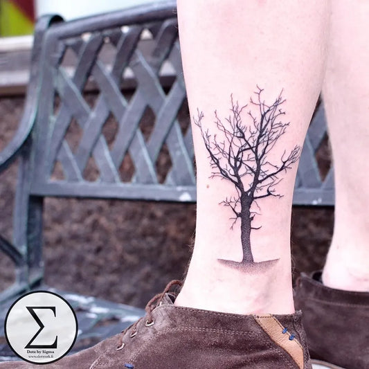 Small Black and Grey Bare Tree Tattoo on Men Leg by @dotsbysigma