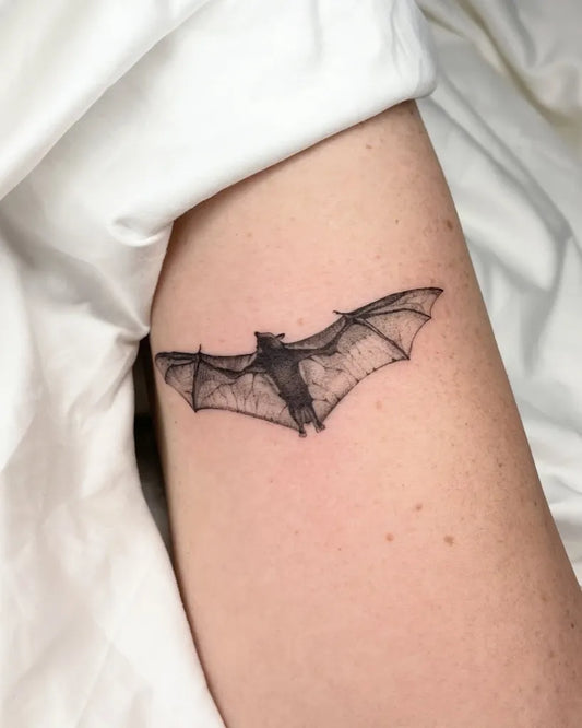 Small Black and Grey Bat Tattoo on Women Arm by @h.j.tattoo_