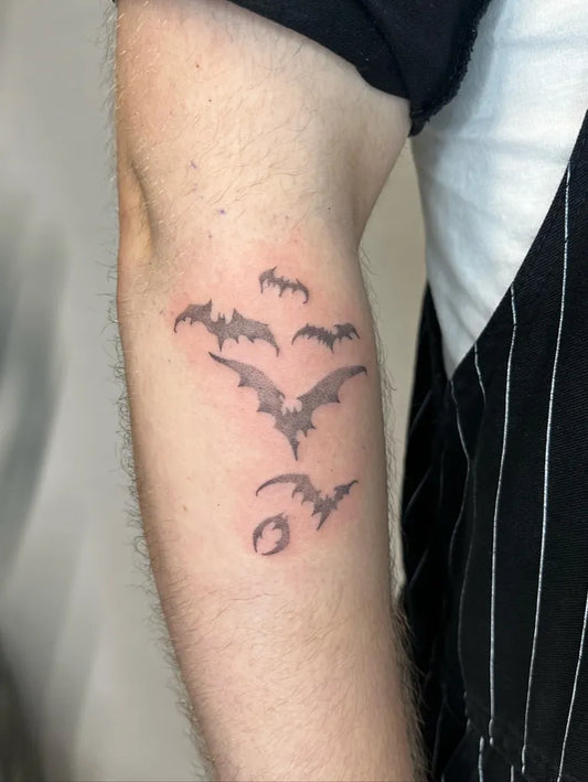 Small Black and Grey Bats Tattoo on Men Arm by @froglounge