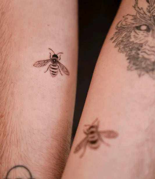 Small Black and Grey Bee on Women Arm Tattoo by @bona_ttoo