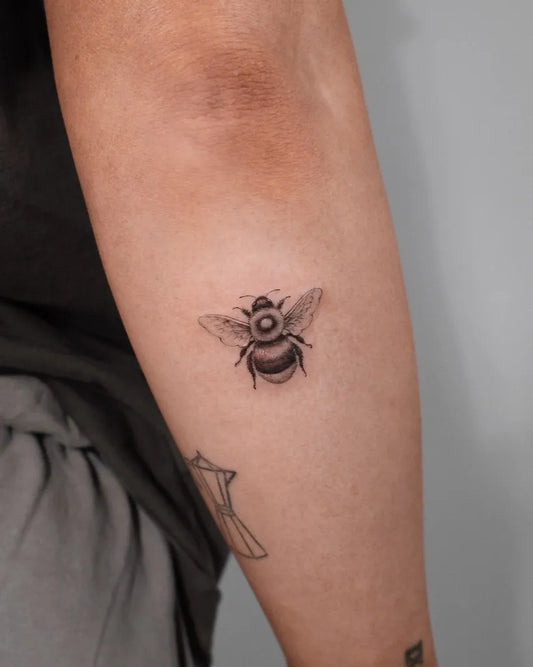 Small Black and Grey Bee on Women Arm Tattoo by @its.freegee