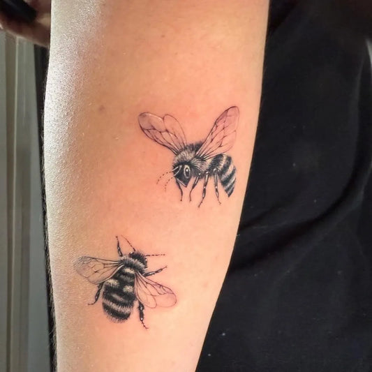 Small Black and Grey Bee on Women Arm Tattoo by @juhee_ink