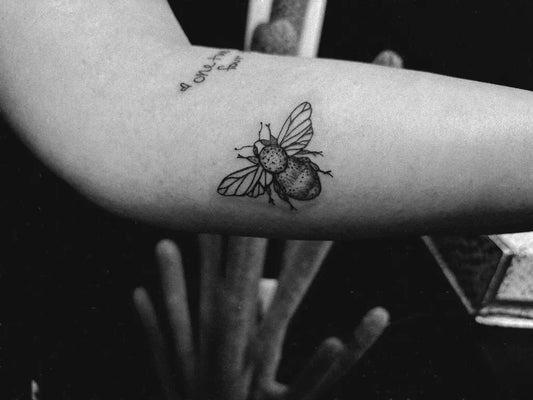 Small Black and Grey Bee on Women Arm Tattoo by @leartistry_ink